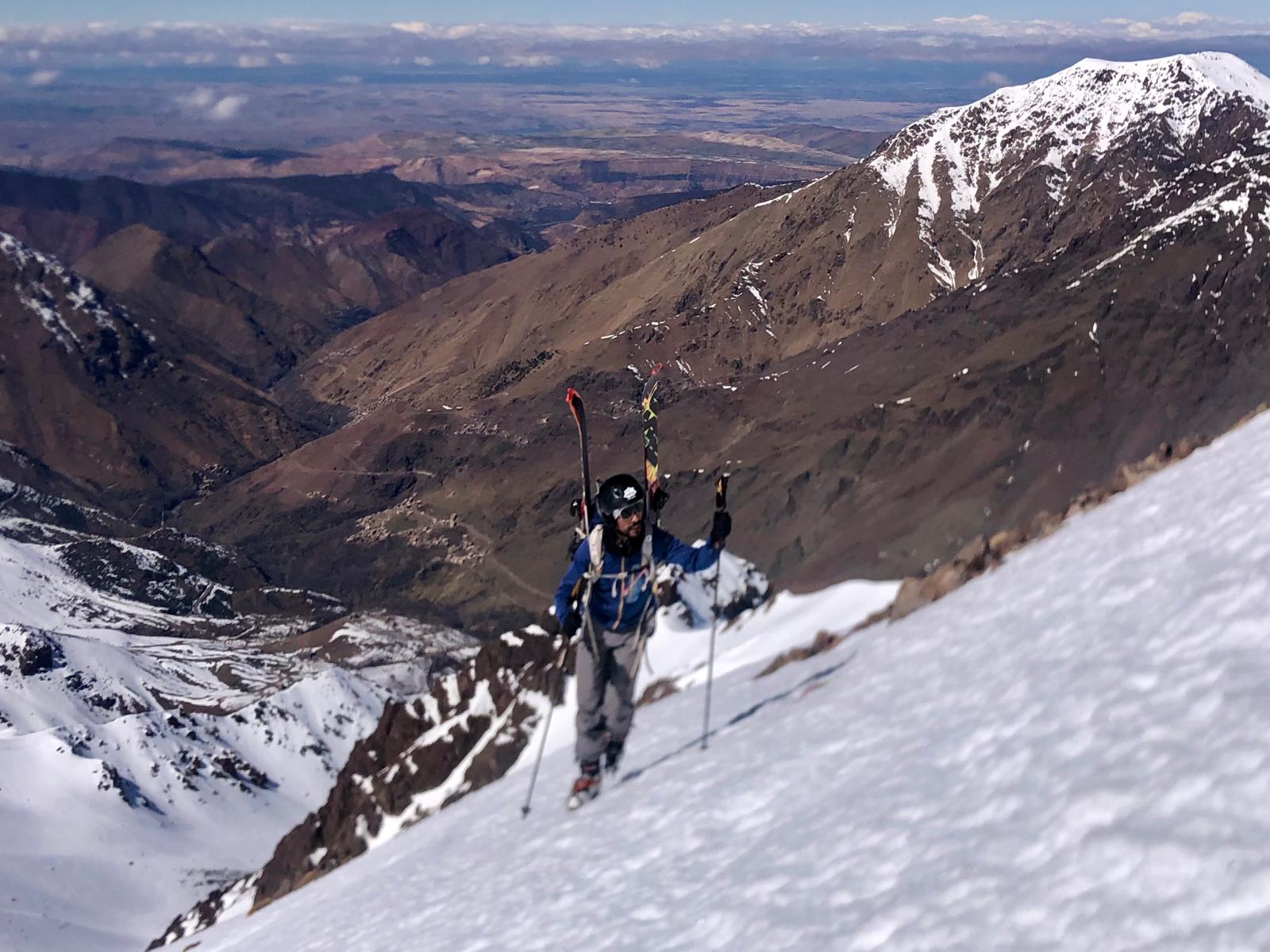 Ski touring expedition from Tachddirt village towards Bougnousene Peak in Morocco's snowy High Atlas Mountains.
